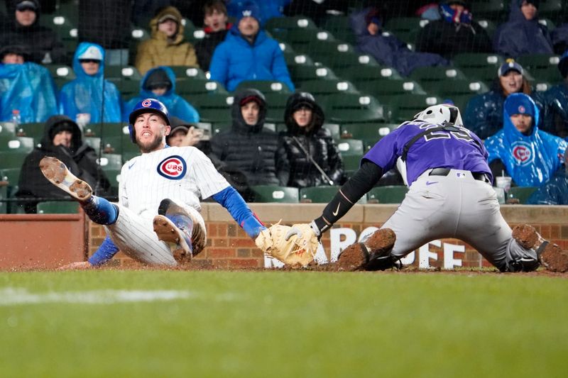 Apr 3, 2024; Chicago, Illinois, USA; Chicago Cubs pinch-hitter Miles Mastrobuoni (20) is safe at home plate as Colorado Rockies catcher Jacob Stallings (25) cant’t tag him out during the ninth inning at Wrigley Field. Mandatory Credit: David Banks-USA TODAY Sports