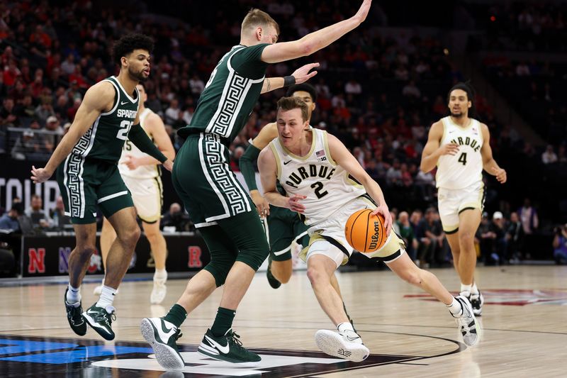 Mar 15, 2024; Minneapolis, MN, USA; Purdue Boilermakers guard Fletcher Loyer (2) works towards the basket as Michigan State Spartans center Carson Cooper (15) defends during the first half at Target Center. Mandatory Credit: Matt Krohn-USA TODAY Sports