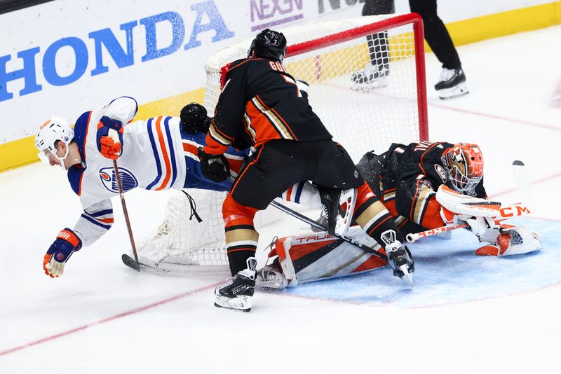 Feb 9, 2024; Anaheim, California, USA; Edmonton Oilers left wing Zach Hyman (18) trips over Anaheim Ducks goaltender Lukas Dostal (1) as Dostal makes a save during the third period of a game at Honda Center. Mandatory Credit: Jessica Alcheh-USA TODAY Sports