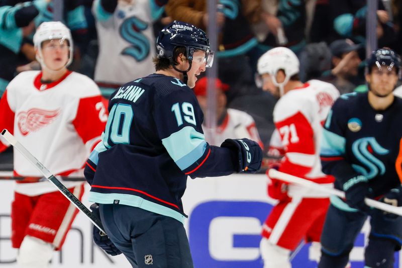 Feb 19, 2024; Seattle, Washington, USA; Seattle Kraken left wing Jared McCann (19) celebrates after scoring a power play goal against the Detroit Red Wings during the first period at Climate Pledge Arena. Mandatory Credit: Joe Nicholson-USA TODAY Sports