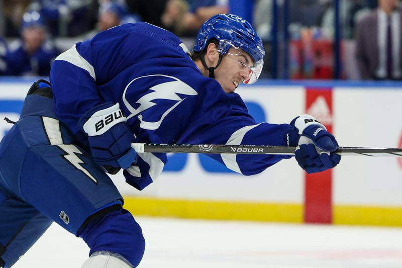 Feb 22, 2024; Tampa, Florida, USA;  Tampa Bay Lightning defenseman Haydn Fleury (7) shoots the puck against the Washington Capitals in the first period at Amalie Arena. Mandatory Credit: Nathan Ray Seebeck-USA TODAY Sports