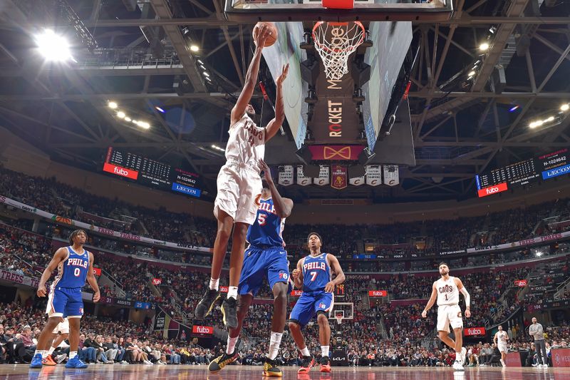 CLEVELAND, OH - MARCH 29: Evan Mobley #4 of the Cleveland Cavaliers drives to the basket during the gameagainst the Philadelphia 76ers on March 29, 2024 at Rocket Mortgage FieldHouse in Cleveland, Ohio. NOTE TO USER: User expressly acknowledges and agrees that, by downloading and/or using this Photograph, user is consenting to the terms and conditions of the Getty Images License Agreement. Mandatory Copyright Notice: Copyright 2024 NBAE (Photo by David Liam Kyle/NBAE via Getty Images)