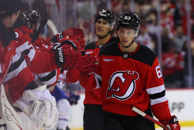 Nov 7, 2024; Newark, New Jersey, USA; New Jersey Devils left wing Jesper Bratt (63) celebrates his goal against the Montreal Canadiens during the third period at Prudential Center. Mandatory Credit: Ed Mulholland-Imagn Images