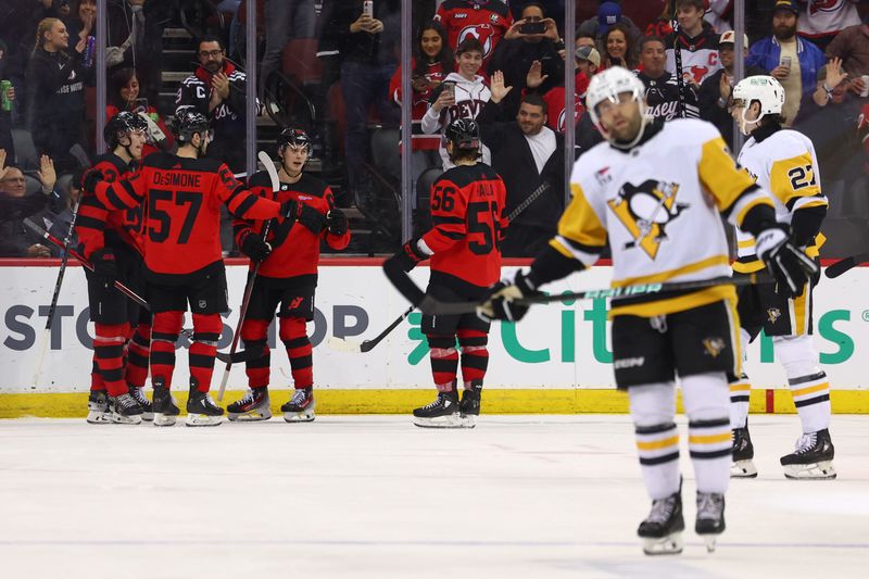 Mar 19, 2024; Newark, New Jersey, USA; New Jersey Devils right wing Alexander Holtz (10) celebrates his goal against the Pittsburgh Penguins during the third period at Prudential Center. Mandatory Credit: Ed Mulholland-USA TODAY Sports