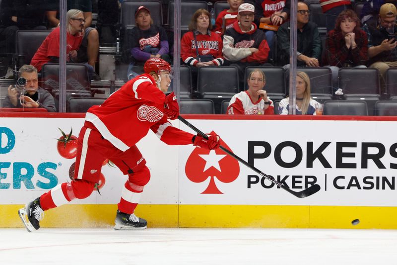 Oct 3, 2024; Detroit, Michigan, USA;  Detroit Red Wings defenseman Simon Edvinsson (77) skates with the puck in the first period against the Toronto Maple Leafs at Little Caesars Arena. Mandatory Credit: Rick Osentoski-Imagn Images