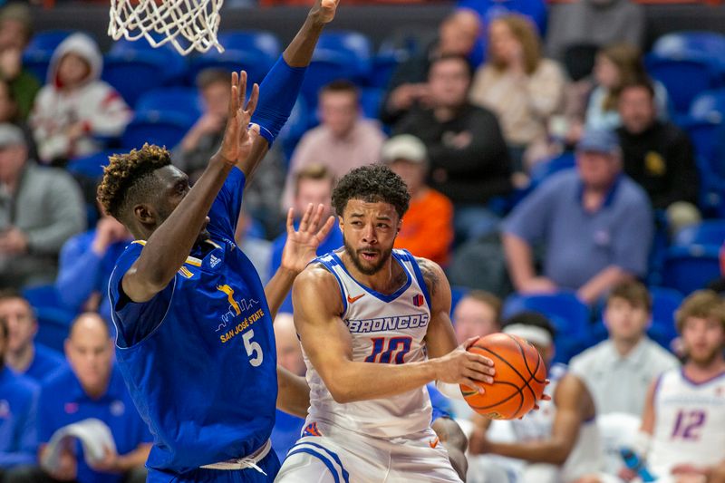 Jan 3, 2023; Boise, Idaho, USA; Boise State Broncos guard Marcus Shaver Jr. (10) drives to the basket against San Jose State Spartans center Ibrahima Diallo (5) during the second half at ExtraMile Arena. Mandatory Credit: Brian Losness-USA TODAY Sports

