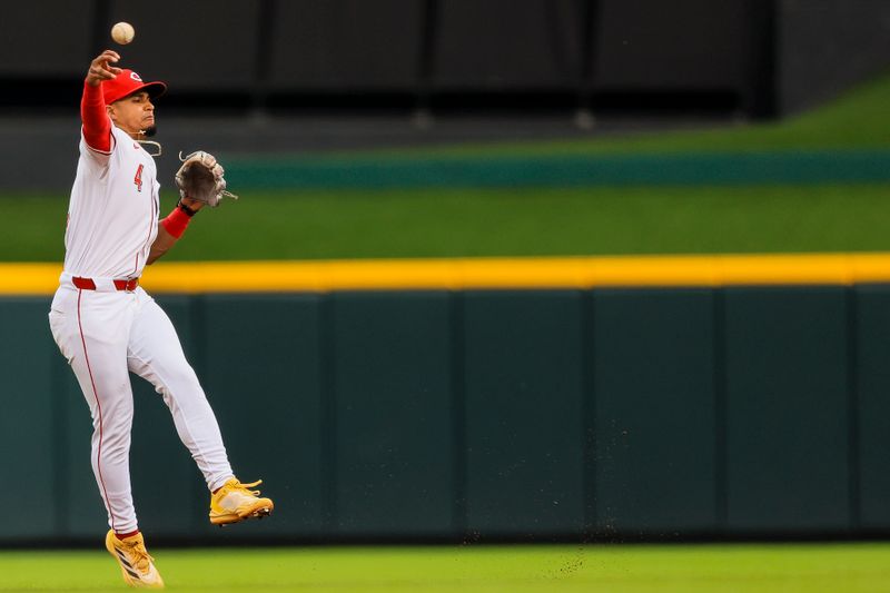 Jul 9, 2024; Cincinnati, Ohio, USA; Cincinnati Reds second baseman Santiago Espinal (4) throws to first to get Colorado Rockies designated hitter Elias Diaz (not pictured) out in the second inning at Great American Ball Park. Mandatory Credit: Katie Stratman-USA TODAY Sports