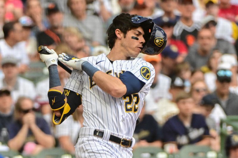 May 27, 2023; Milwaukee, Wisconsin, USA; Milwaukee Brewers left fielder Christian Yelich (22) loses his helmet as he strikes out in the third inning against the San Francisco Giants at American Family Field. Mandatory Credit: Benny Sieu-USA TODAY Sports