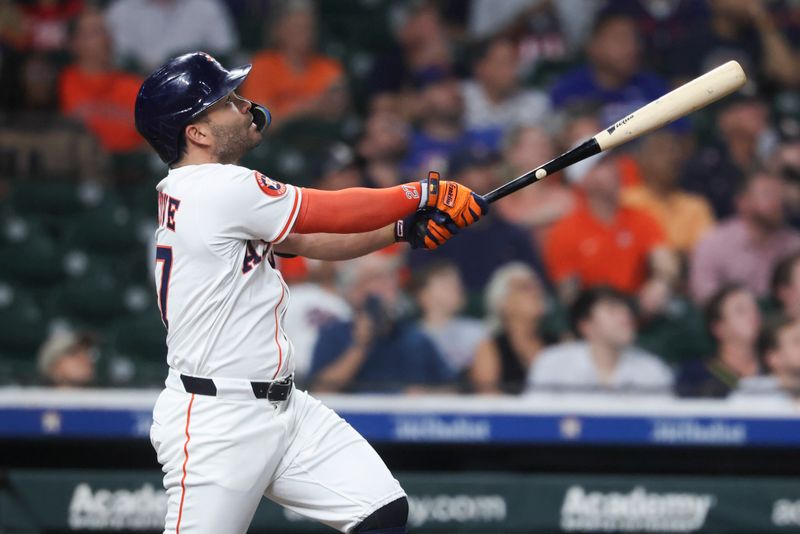 Sep 16, 2025; Houston, Texas, USA; Houston Astros second baseman Jose Altuve (27) drives in a run with a sacrifice fly during the first inning against the Texas Rangers at Daikin Park. Mandatory Credit: Troy Taormina-Imagn Images