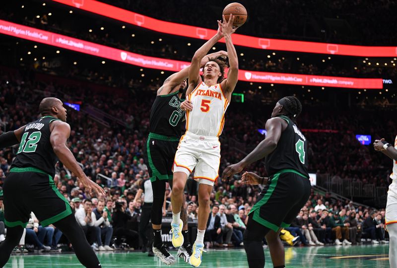 BOSTON, MASSACHUSETTS - NOVEMBER 12: Dyson Daniels #5 of the Atlanta Hawks battles for against Jayson Tatum #0 of the Boston Celtics during the first half of an Emirates NBA cup game at TD Garden on November 12, 2024 in Boston, Massachusetts. NOTE TO USER: User expressly acknowledges and agrees that, by downloading and or using this photograph, User is consenting to the terms and conditions of the Getty Images License Agreement. (Photo by China Wong/Getty Images)