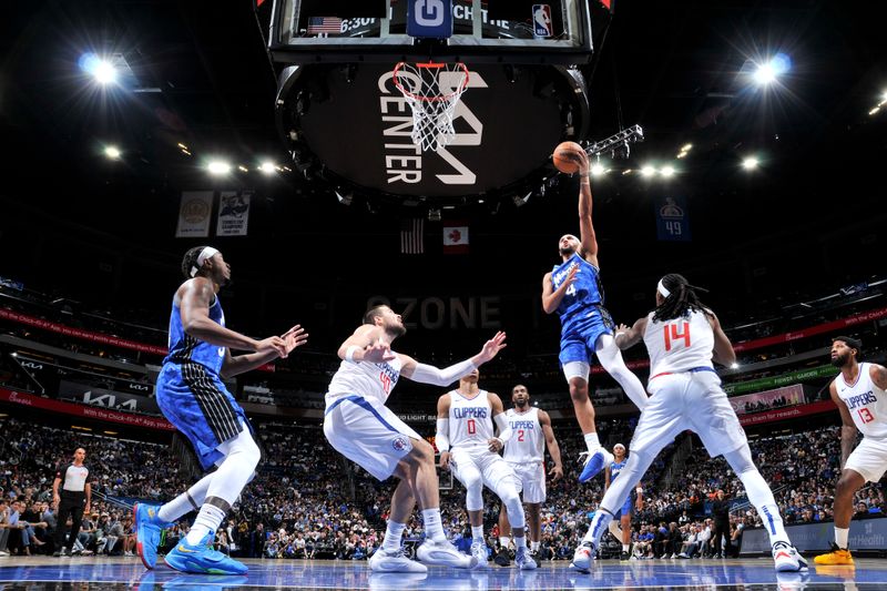 ORLANDO, FL - MARCH 29: Jalen Suggs #4 of the Orlando Magic drives to the basket during the game against the LA Clippers on March 29, 2024 at the Kia Center in Orlando, Florida. NOTE TO USER: User expressly acknowledges and agrees that, by downloading and or using this photograph, User is consenting to the terms and conditions of the Getty Images License Agreement. Mandatory Copyright Notice: Copyright 2024 NBAE (Photo by Fernando Medina/NBAE via Getty Images)