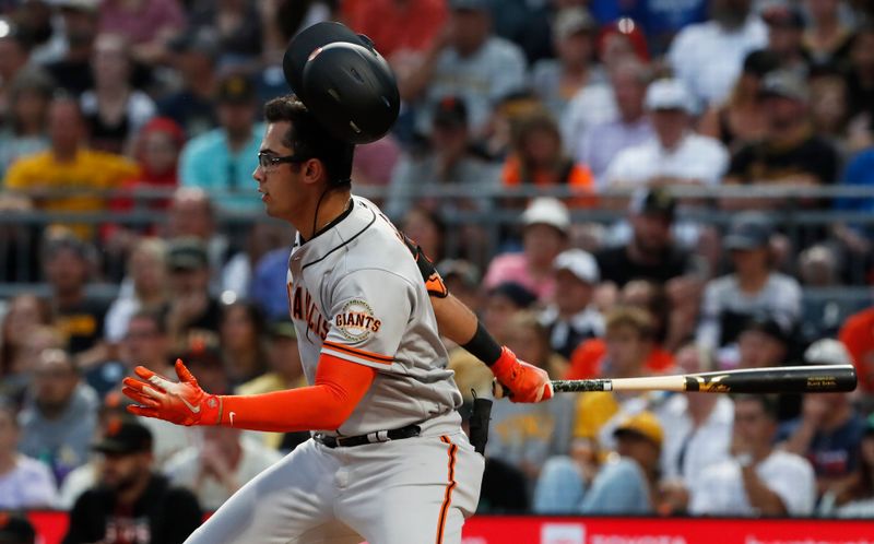 Jul 15, 2023; Pittsburgh, Pennsylvania, USA;  San Francisco Giants left fielder Blake Sabol (2) loses his helmet on a swing against the Pittsburgh Pirates during the second inning at PNC Park. Mandatory Credit: Charles LeClaire-USA TODAY Sports