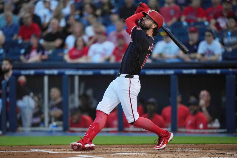 Mar 8, 2024; West Palm Beach, Florida, USA; Washington Nationals designated hitter Jesse Winker (6) hits a single to left field in the first inning against the St. Louis Cardinals at CACTI Park of the Palm Beaches. Mandatory Credit: Jim Rassol-USA TODAY Sports