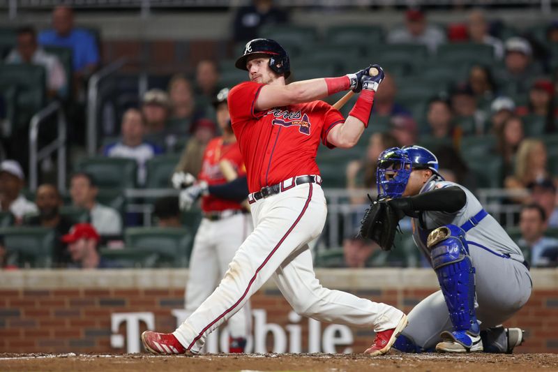 Sep 27, 2024; Atlanta, Georgia, USA; Atlanta Braves catcher Sean Murphy (12) hits a two-run home run against the Kansas City Royals in the fourth inning at Truist Park. Mandatory Credit: Brett Davis-Imagn Images