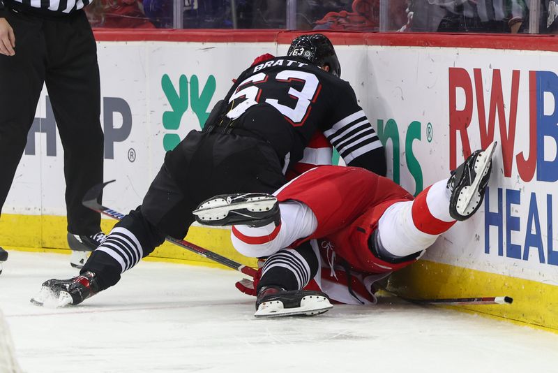 Dec 23, 2023; Newark, New Jersey, USA; New Jersey Devils left wing Jesper Bratt (63) and Detroit Red Wings defenseman Ben Chiarot (8) fight during the second period at Prudential Center. Mandatory Credit: Ed Mulholland-USA TODAY Sports