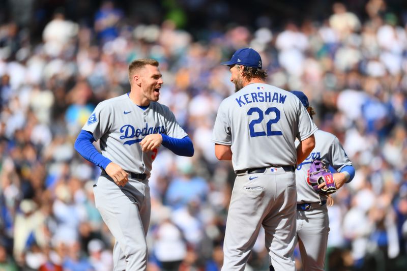 Sep 28, 2025; Seattle, Washington, USA; Los Angeles Dodgers first baseman Freddie Freeman (5) pulls starting pitcher Clayton Kershaw (22) from the game during the sixth inning at T-Mobile Park. Mandatory Credit: Steven Bisig-Imagn Images