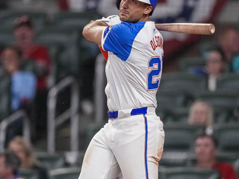 Apr 8, 2024; Cumberland, Georgia, USA; Atlanta Braves first baseman Matt Olson (28) hits a double against the New York Mets during the ninth inning at Truist Park. Mandatory Credit: Dale Zanine-USA TODAY Sports