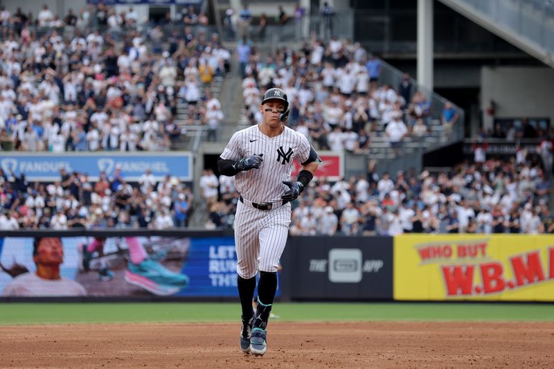 May 23, 2024; Bronx, New York, USA; New York Yankees center fielder Aaron Judge (99) rounds the bases after hitting a solo home run against the Seattle Mariners during the third inning at Yankee Stadium. Mandatory Credit: Brad Penner-USA TODAY Sports