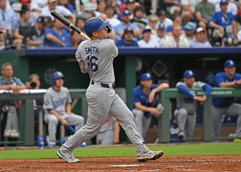 Jun 29, 2025; Kansas City, Missouri, USA;  Los Angeles Dodgers catcher Will Smith (16) hits a solo home run in the sixth inning against the Kansas City Royals at Kauffman Stadium. Mandatory Credit: Peter Aiken-Imagn Images