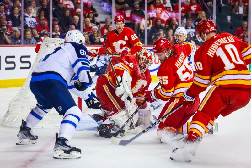 Oct 11, 2023; Calgary, Alberta, CAN; Calgary Flames goaltender Jacob Markstrom (25) makes a save against the Winnipeg Jets during the first period at Scotiabank Saddledome. Mandatory Credit: Sergei Belski-USA TODAY Sports