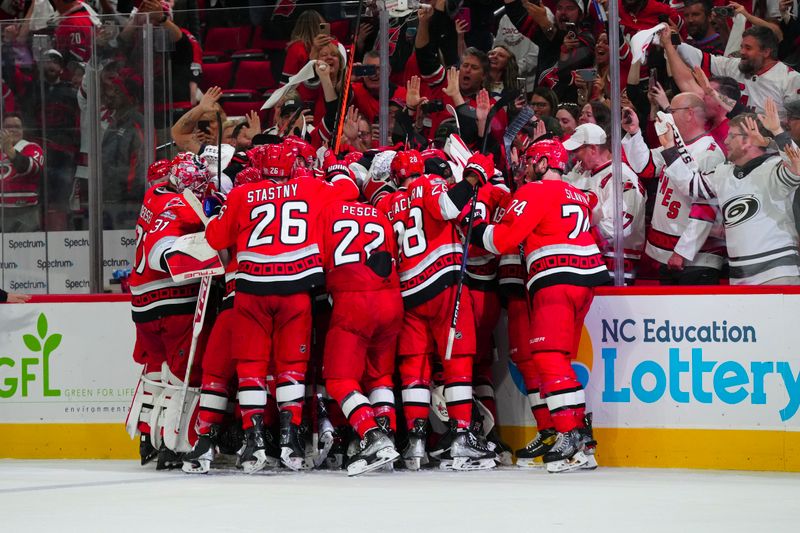 May 11, 2023; Raleigh, North Carolina, USA; Carolina Hurricanes players celebrate their overtime victory against the New Jersey Devils in game five of the second round of the 2023 Stanley Cup Playoffs at PNC Arena. Mandatory Credit: James Guillory-USA TODAY Sports