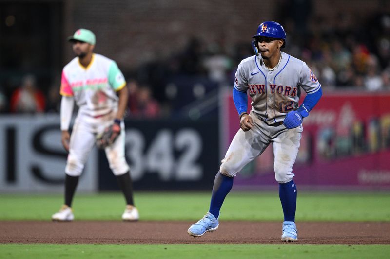 Jul 7, 2023; San Diego, California, USA; New York Mets shortstop Francisco Lindor (12) leads off second base as San Diego Padres shortstop Xander Bogaerts (left) looks on during the 10th inning at Petco Park. Mandatory Credit: Orlando Ramirez-USA TODAY Sports