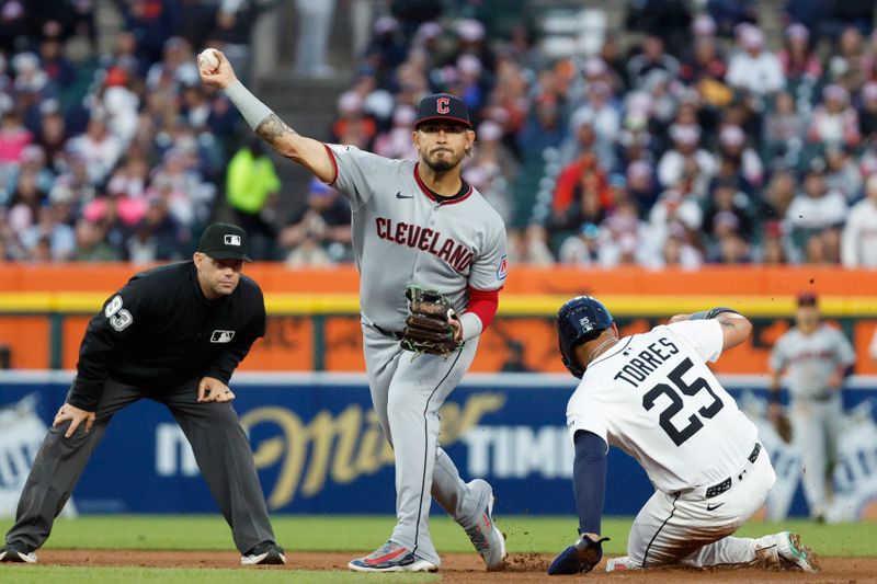 May 24, 2025; Detroit, Michigan, USA; Cleveland Guardians second baseman Gabriel Arias (13) throws to first after tagging Detroit Tigers second base Gleyber Torres (25) out at second during the fifth inning at Comerica Park. Mandatory Credit: Brian Bradshaw Sevald-Imagn Images