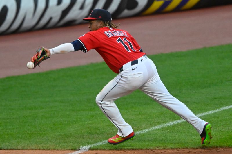 Apr 22, 2025; Cleveland, Ohio, USA; Cleveland Guardians third baseman Jose Ramirez (11) reaches for the ball on a base hit by the New York Yankees in the sixth inning at Progressive Field. Mandatory Credit: David Richard-Imagn Images