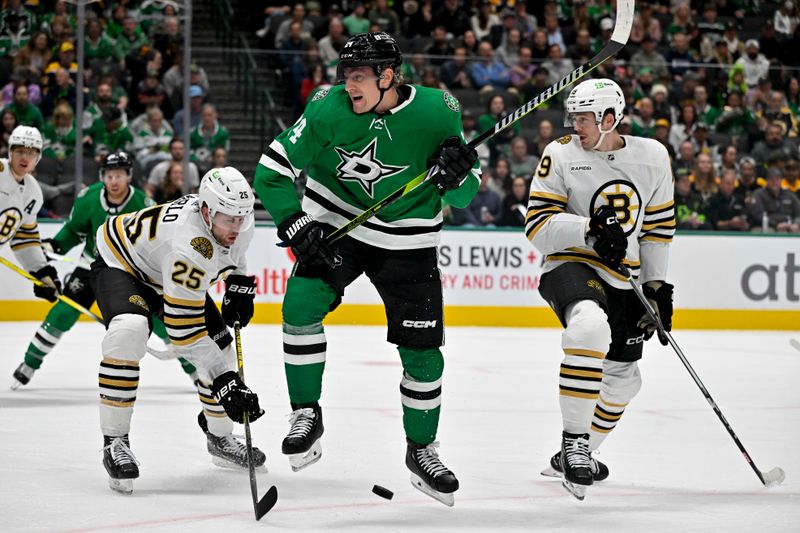 Nov 6, 2023; Dallas, Texas, USA; Dallas Stars center Roope Hintz (24) reacts to getting hit with a puck as Boston Bruins defenseman Brandon Carlo (25) and center Johnny Beecher (19) look for the rebound during the second period at the American Airlines Center. Mandatory Credit: Jerome Miron-USA TODAY Sports