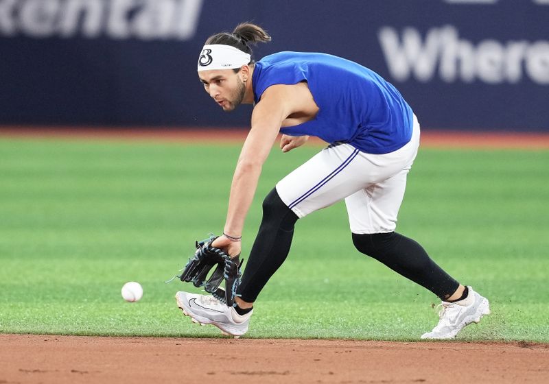 Apr 26, 2024; Toronto, Ontario, CAN; Toronto Blue Jays shortstop Bo Bichette (11) fields a ball during batting practice before a game against the Los Angeles Dodgers at Rogers Centre. Mandatory Credit: Nick Turchiaro-USA TODAY Sports