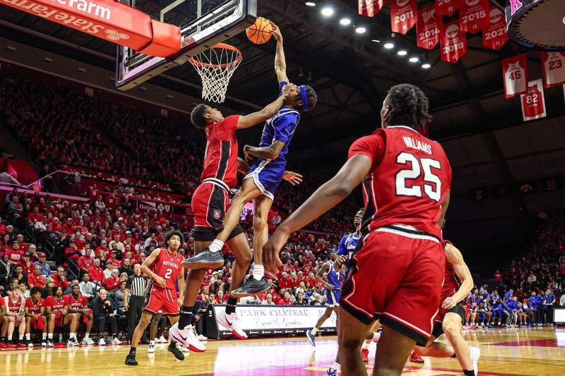 Dec 14, 2024; Piscataway, New Jersey, USA;  Seton Hall Pirates guard Chaunce Jenkins (2) goes up for a dunk against Rutgers Scarlet Knights guard Ace Bailey (4) during the first half at Jersey Mike's Arena. Mandatory Credit: Vincent Carchietta-Imagn Images