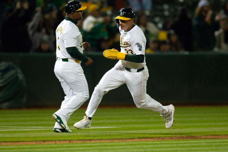 May 24, 2024; Oakland, California, USA; Oakland Athletics center fielder JJ Bleday (33) rounds third base and heads home on an RBI single by Miguel Andujar during the seventh inning against the Houston Astros at Oakland-Alameda County Coliseum. Mandatory Credit: D. Ross Cameron-USA TODAY Sports