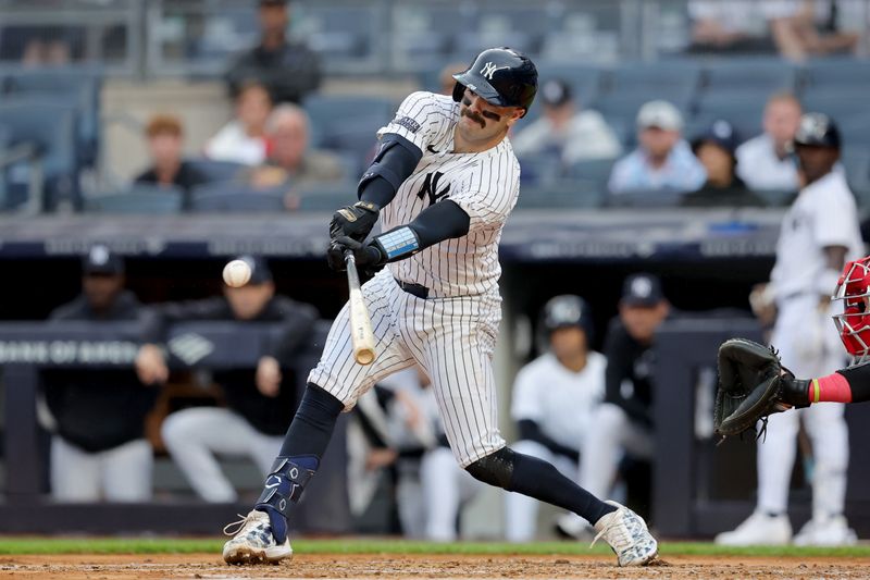 Aug 7, 2024; Bronx, New York, USA; New York Yankees catcher Austin Wells (28) hits an RBI single against the Los Angeles Angels during the first inning at Yankee Stadium. Mandatory Credit: Brad Penner-USA TODAY Sports