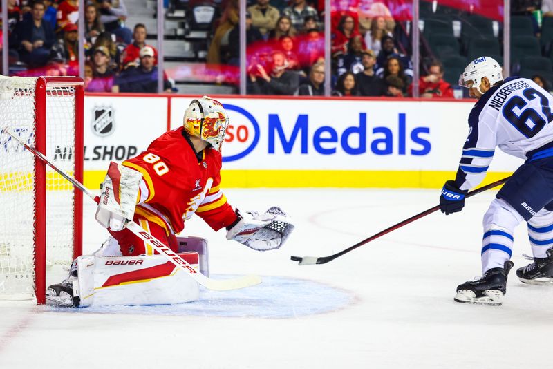 Oct 4, 2024; Calgary, Alberta, CAN; Winnipeg Jets right wing Nino Niederreiter (62) scores a goal against Calgary Flames goaltender Dan Vladar (80) during the first period at Scotiabank Saddledome. Mandatory Credit: Sergei Belski-Imagn Images