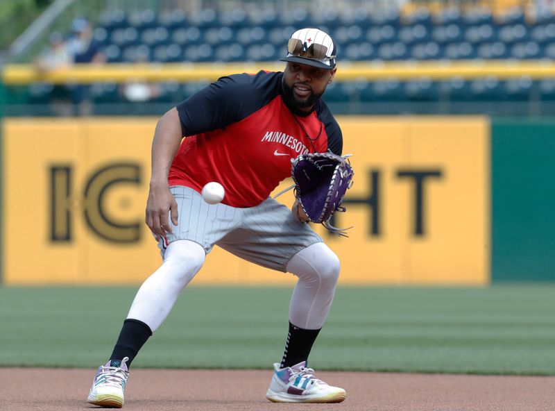 Jun 7, 2024; Pittsburgh, Pennsylvania, USA;  Minnesota Twins first baseman Carlos Santana (30) takes ground balls before the game against the Pittsburgh Pirates at PNC Park. Mandatory Credit: Charles LeClaire-USA TODAY Sports