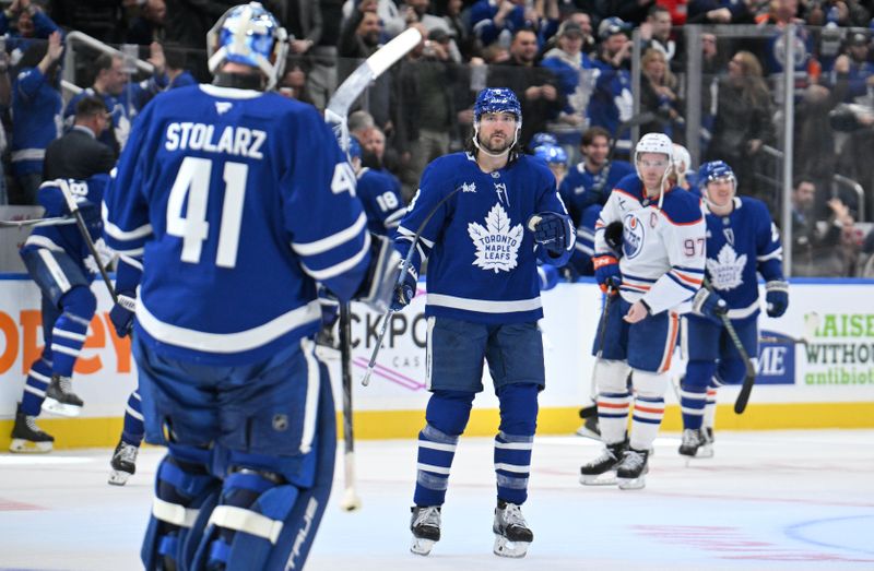 Nov 16, 2024; Toronto, Ontario, CAN;  Toronto Maple Leafs defenseman Chris Tanev (8) skates out to congratulate goalie Anthony Stolarz (41) after an overtime victory against the Edmonton Oilers at Scotiabank Arena. Mandatory Credit: Dan Hamilton-Imagn Images