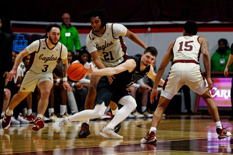 Jan 23, 2024; Blacksburg, Virginia, USA; Virginia Tech Hokies guard Hunter Cattoor (0) is fouled by Boston College Eagles forward Devin McGlockton (21) during the second half at Cassell Coliseum. Mandatory Credit: Peter Casey-USA TODAY Sports