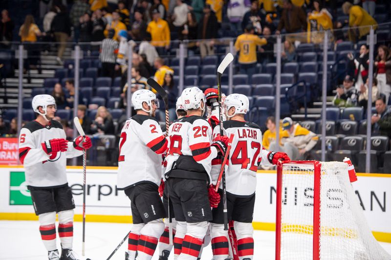 Feb 13, 2024; Nashville, Tennessee, USA; New Jersey Devils goaltender Nico Daws (50) celebrates his win with his teammates against the Nashville Predators  during the third period at Bridgestone Arena. Mandatory Credit: Steve Roberts-USA TODAY Sports