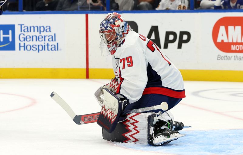 Oct 26, 2024; Tampa, Florida, USA; Washington Capitals goaltender Charlie Lindgren (79) makes a save against the Tampa Bay Lightning during the first period at Amalie Arena. Mandatory Credit: Kim Klement Neitzel-Imagn Images