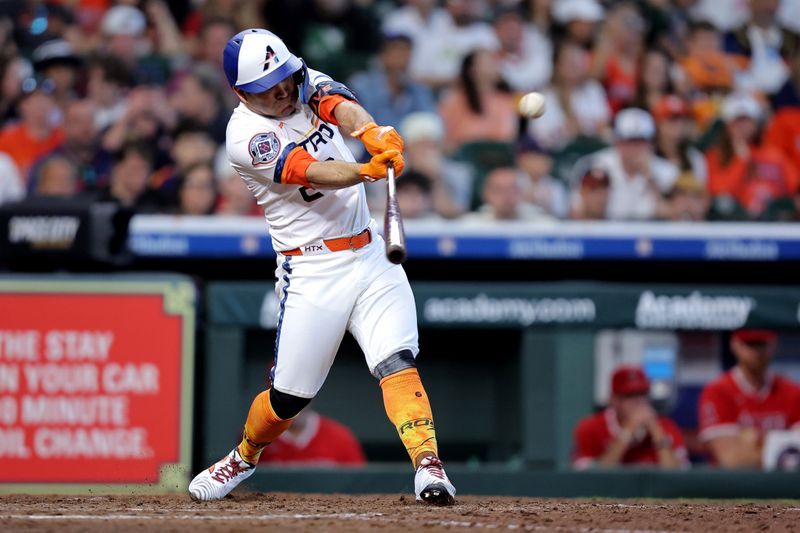 Apr 13, 2025; Houston, Texas, USA; Houston Astros left fielder Jose Altuve (27) hits a sacrifice fly ball to right field scoring a run against the Los Angeles Angels during the seventh inning at Daikin Park. Mandatory Credit: Erik Williams-Imagn Images