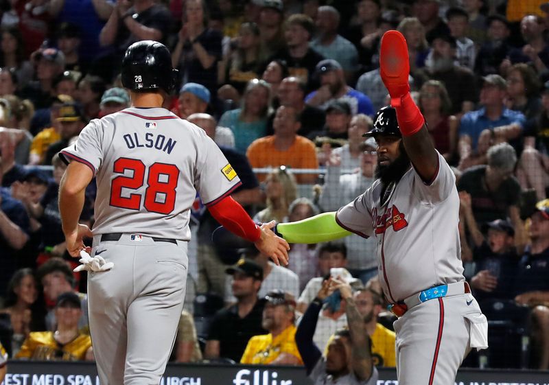 May 24, 2024; Pittsburgh, Pennsylvania, USA;  Atlanta Braves first baseman Matt Olson (28) and designated hitter Marcell Ozuna (right) celebrate after both players scored runs against the Pittsburgh Pirates during the eighth inning at PNC Park. Mandatory Credit: Charles LeClaire-USA TODAY Sports