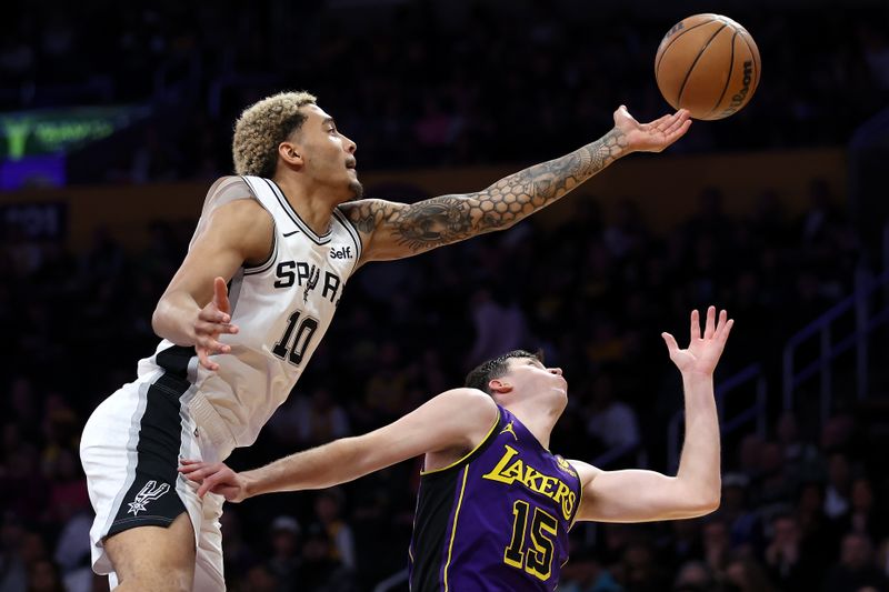 LOS ANGELES, CALIFORNIA - FEBRUARY 23: Jeremy Sochan #10 of the San Antonio Spurs lunges over Austin Reaves #15 of the Los Angeles Lakers for a rebound during the second half of a game at Crypto.com Arena on February 23, 2024 in Los Angeles, California. (Photo by Sean M. Haffey/Getty Images)