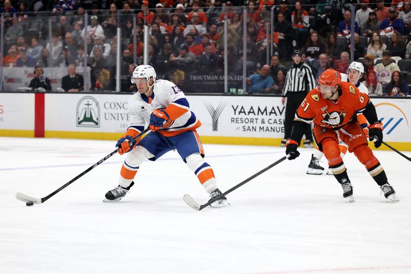 Mar 4, 2026; Anaheim, California, USA;  New York Islanders center Mathew Barzal (13) skates with the puck against Anaheim Ducks left wing Cutter Gauthier (61) during the first period at Honda Center. Mandatory Credit: Kiyoshi Mio-Imagn Images