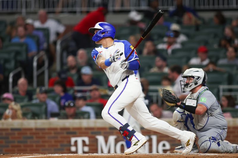 Sep 7, 2024; Atlanta, Georgia, USA; Atlanta Braves third baseman Gio Urshela (9) hits a single against the Toronto Blue Jays in the fifth inning at Truist Park. Mandatory Credit: Brett Davis-Imagn Images
