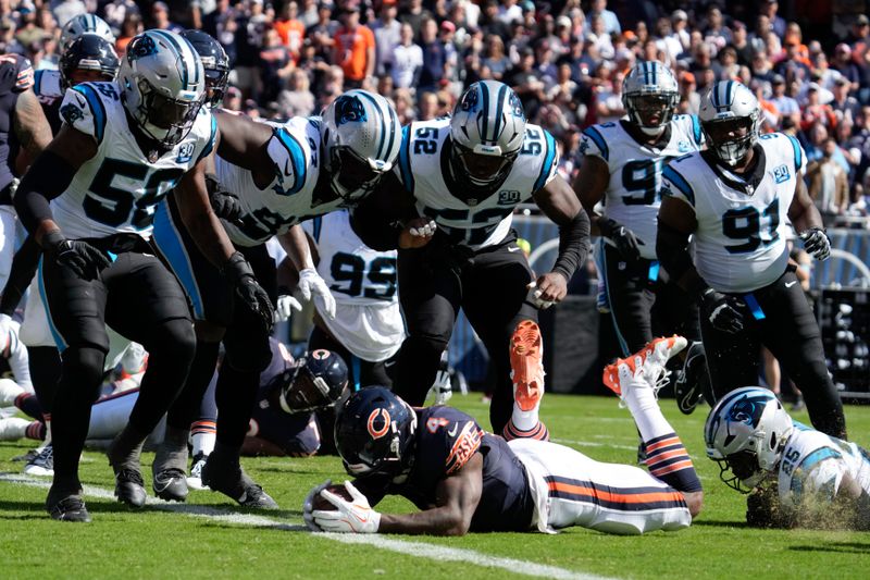 Chicago Bears running back D'Andre Swift (4) is brought down on the one-yard line against the Carolina Panthers during the first half of an NFL football game Sunday, Oct. 6, 2024, in Chicago. (AP Photo/Nam Y. Huh)