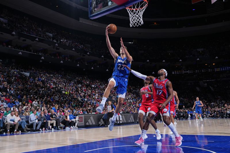 PHILADELPHIA, PA - APRIL 12: Franz Wagner #22 of the Orlando Magic drives to the basket during the game against the Philadelphia 76ers on April 12, 2024 at the Wells Fargo Center in Philadelphia, Pennsylvania NOTE TO USER: User expressly acknowledges and agrees that, by downloading and/or using this Photograph, user is consenting to the terms and conditions of the Getty Images License Agreement. Mandatory Copyright Notice: Copyright 2024 NBAE (Photo by Jesse D. Garrabrant/NBAE via Getty Images)