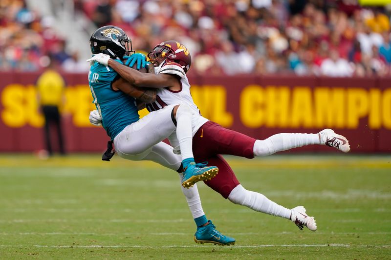 Jacksonville Jaguars wide receiver Marvin Jones Jr. (11) making a catch against Washington Commanders cornerback Kendall Fuller (29) during the second half of an NFL football game, Sunday, Sept. 11, 2022, in Landover, Md. (AP Photo/Patrick Semansky)