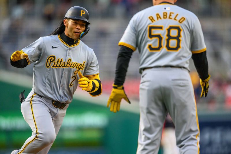 Apr 4, 2024; Washington, District of Columbia, USA; Pittsburgh Pirates designated hitter Connor Joe (2) shakes hands with third base coach Mike Rabelo after hitting a home run during the fifth inning against the Washington Nationals at Nationals Park. Mandatory Credit: Reggie Hildred-USA TODAY Sports