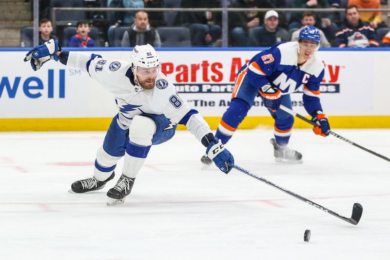 Feb 24, 2024; Elmont, New York, USA;  Tampa Bay Lightning defenseman Erik Cernak (81) reaches for the puck in the second period against the New York Islanders at UBS Arena. Mandatory Credit: Wendell Cruz-USA TODAY Sports