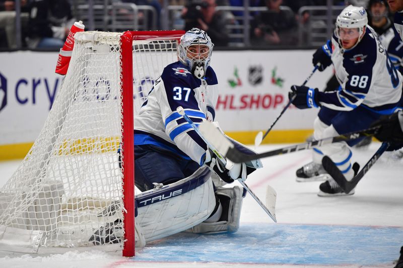 Dec 13, 2023; Los Angeles, California, USA; Winnipeg Jets goaltender Connor Hellebuyck (37) defends the goal against the Los Angeles Kings during the second period at Crypto.com Arena. Mandatory Credit: Gary A. Vasquez-USA TODAY Sports